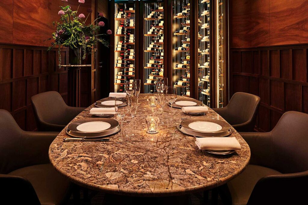 Odette three‑Michelin‑star restaurant interior at Singapore’s National Gallery with refined neutral tones, minimalist decor, and curated art.