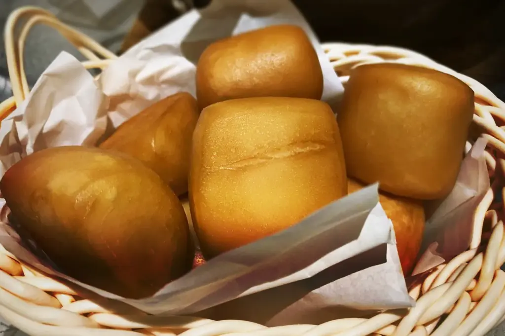 A basket of golden-brown deep-fried mantou buns, a classic side for dipping in chili crab sauce at JUMBO Seafood.