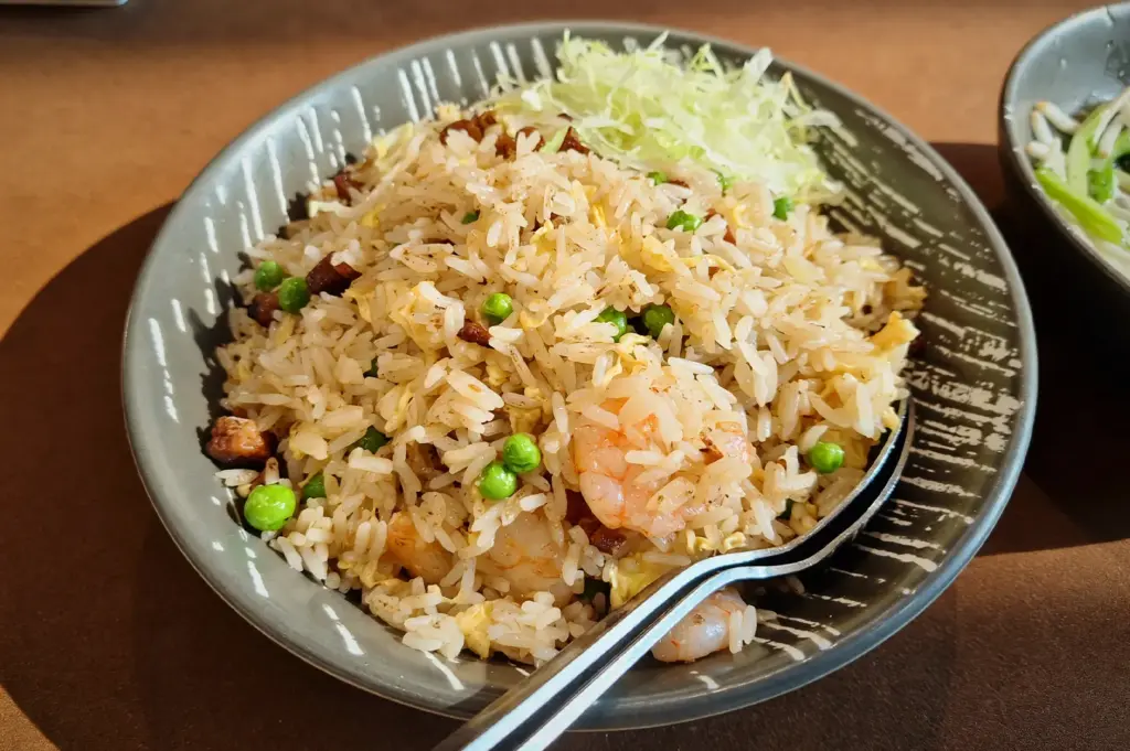 A delicious bowl of JUMBO Seafood’s, Supreme Seafood fried rice topped with shredded lettuce.