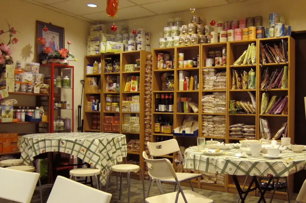 Shelves stocked with organic groceries and healthy food products inside New Green Pasture Cafe, Fortune Centre.
