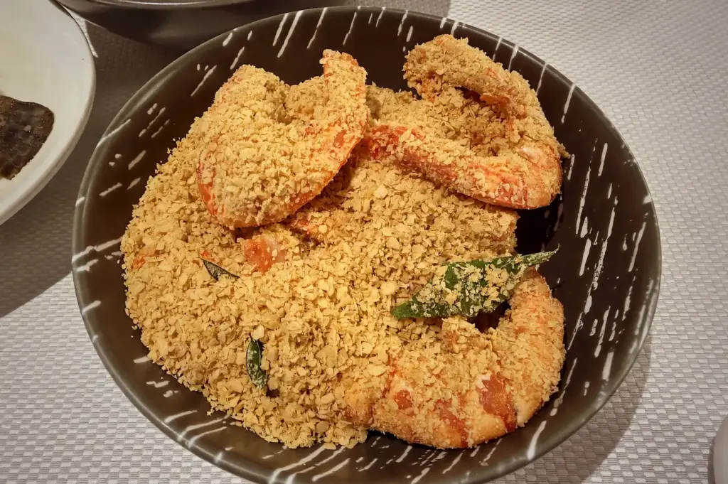Crispy cereal prawns, a popular Singaporean seafood specialty, served in a bowl at JUMBO Seafood.