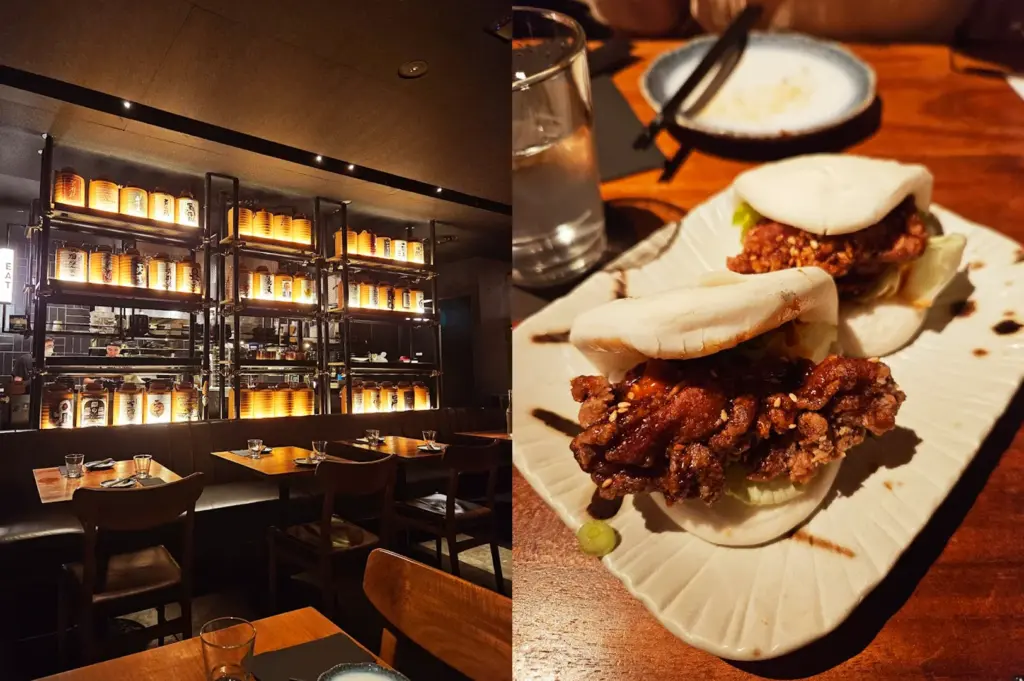 Modern aesthetic of Neon Pigeon restaurant with illuminated shelves, featuring a serving of their signature KFC Bao (Korean Fried Chicken Bao) on a textured plate.