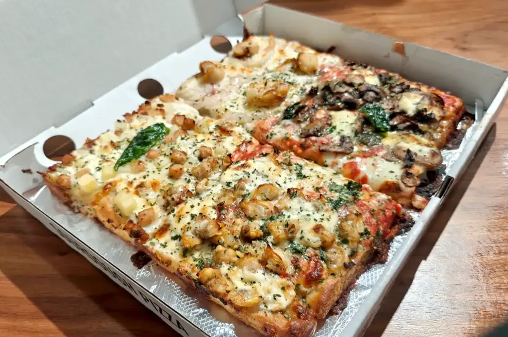 Goldenroy Sourdough Pizza square-cut delivery box featuring a variety of flavors including browned butter scallops with onions in Singapore.
