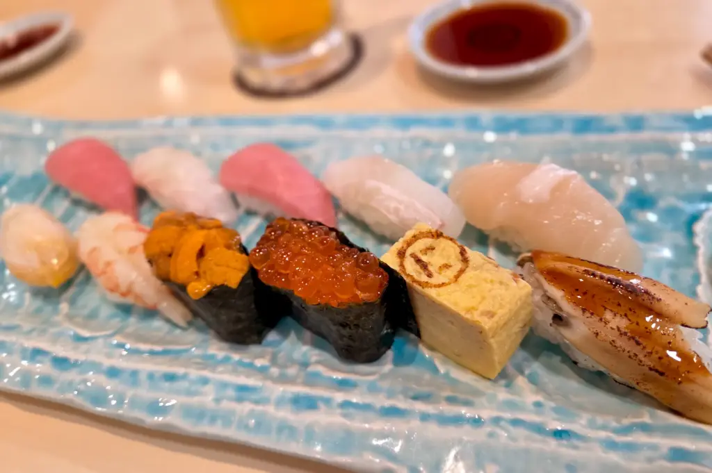 A beautifully arranged selection of nigiri sushi at Tomi Sushi, Millenia Walk, including fresh tuna, salmon, uni, and tamago.